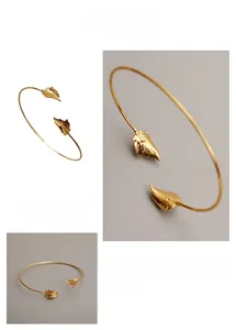Macro detail of French vintage wavy leaf bangle with delicate gold-plated metal textures