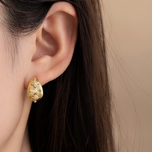 Elegant C-shaped golden drop earrings with zircon stars and brushed metal texture