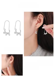 Detail showing 3D schnauzer dog hoop earrings in silver on a model for scale and style
