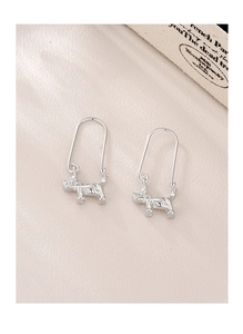 Close-up of Schnauzer dog drop earrings with long U-shaped hooks on a textured surface