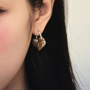 Dachshund heart earrings featuring a golden puppy on silver charms for women