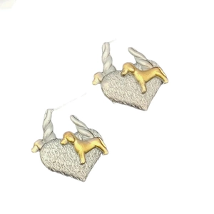 Detailed view of silver heart earrings with a gold dachshund puppy design