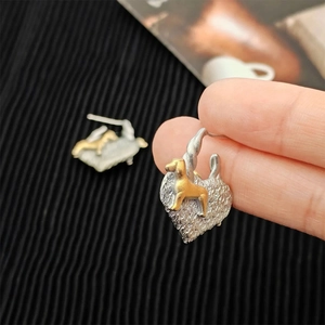 Two-tone heart dog stud earrings with brushed silver texture and golden puppy relief