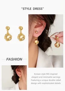 Detail of gold ball earrings with geometric pendants and tiny embedded crystals