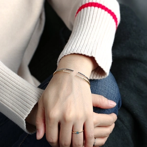 Minimalist open zircon bracelets in gold and silver finish shown on a model's wrist