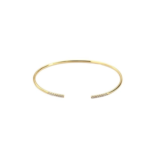 Close-up of a gold open cuff bracelet featuring sparkling pave cubic zirconia on the tips
