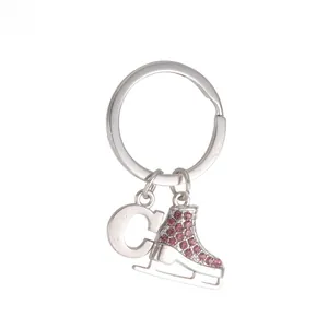 Macro shot of silver keyring with a pink rhinestone encrusted ice skate pendant
