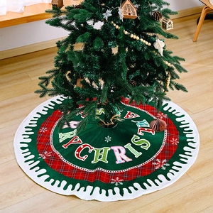 Christmas tree skirt with Merry Christmas text, snowflake patterns, and red plaid borders