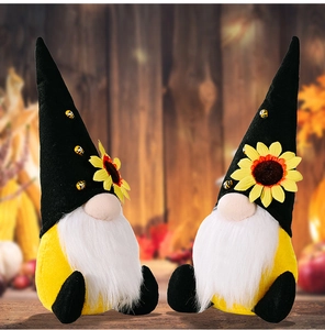 Close-up of autumn gnomes featuring sunflower hats and tiny bees for harvest decor