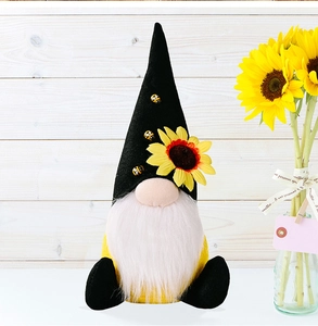 Detail of sunflower gnome plush featuring yellow body, bee accents and white beard
