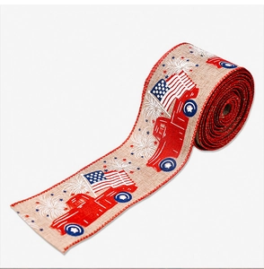 Close-up of patriotic burlap ribbon with vintage red truck and American flag prints