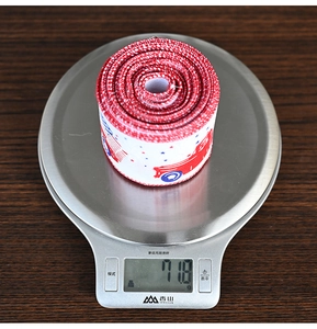 Close-up of Independence Day themed ribbon roll on a digital scale weighing 71.8g