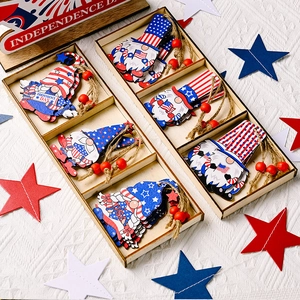 Close-up of Independence Day wooden gnome pendants with USA flag colors in a 3-grid tray