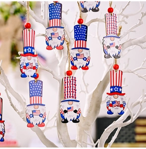 Detailed close-up of Independence Day gnome wooden ornaments hanging on white branches