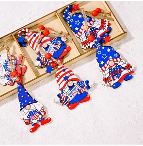 Detailed view of 4th of July wooden gnome ornaments with stars and stripes in a wood box