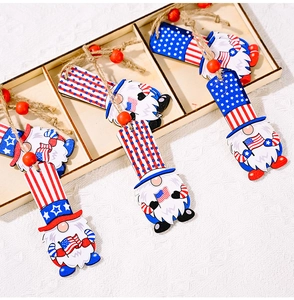 Detail of wooden 4th of July gnome ornaments with stars and stripes hanging on natural jute rope