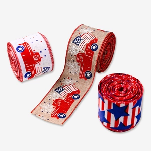 Three rolls of Independence Day ribbons with truck and US flag patterns on grey background