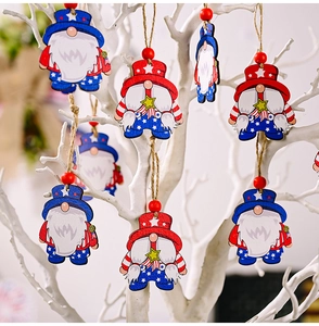 Detail of wooden gnome ornaments with American flag motifs hanging on white branches