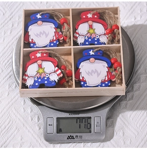 Detailed top view of four patriotic gnome wooden ornaments weighing 116g on a scale