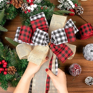 Plaid rustic Christmas tree topper bow with red and black buffalo check on wood background