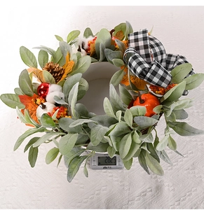 Detail view of the 282g autumn wreath with maple leaves, pumpkins, and a plaid bow
