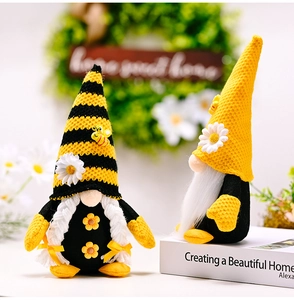 Detail of bee gnomes with knitted hats, daisy accents and plush braids for home decor
