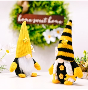 Close-up of handmade bee gnomes with knitted hats and daisy accents for home decor