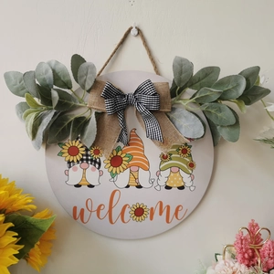 Rustic sunflower welcome sign with wooden base, eucalyptus leaves and decorative bows