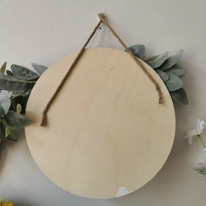 Close-up of circular unfinished wood sign with rustic jute rope for DIY farmhouse decor