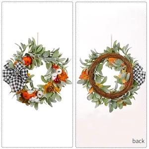 Autumn wreath with cotton pumpkins and pine cones on a natural rattan base for decoration