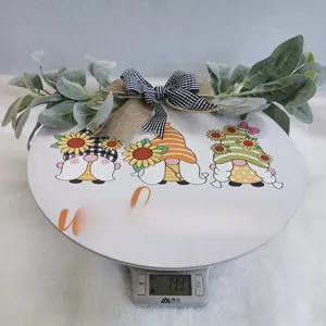 Detail of sunflower gnome welcome sign featuring rustic burlap bows and green leaves