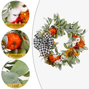 Autumn wreath with white cotton pumpkins and black plaid bow for Thanksgiving decor