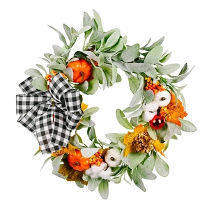 Autumn wreath with white cotton balls, pumpkins and a black white buffalo plaid bow