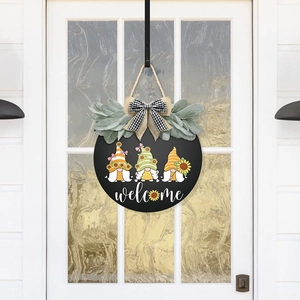 Detail of wooden welcome sign with hand-painted gnomes and sunflower accents on white door