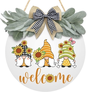 Close-up of farmhouse welcome sign with rustic gnomes and decorative sunflower wreath