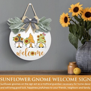 Detail of wooden sunflower gnome welcome sign with burlap bow and farmhouse greenery
