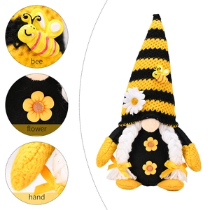 Knitted bee gnome decoration with daisy accents and striped hat for home harvest festival