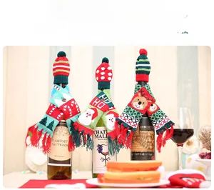 Detailed view of three knitted Christmas wine bottle scarf and hat sets with festive patterns