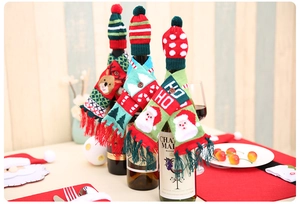 Close-up of knitted Christmas wine bottle hat and scarf set with wooden buttons