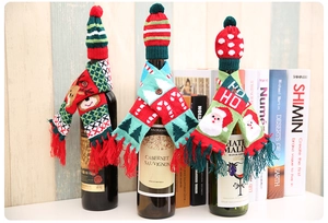 Detailed knitted Christmas wine bottle set with festive scarves and mini pom-pom hats