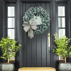 Artificial lamb's ear and eucalyptus wreath with a striped bow on a black front door