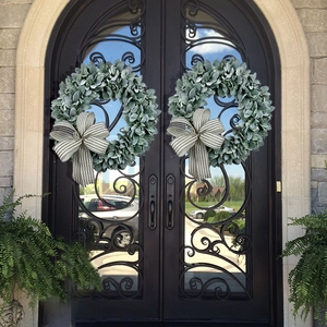 Artificial lamb's ear and eucalyptus wreaths with striped bows on black front door