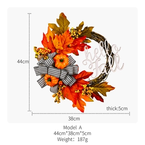 Close-up of autumn wreath with maple leaves, pumpkins, berries and Hello Fall wooden sign