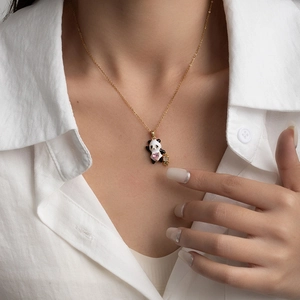 Collana con ciondolo panda e gemma a cuore rosa con catena dorata su modella