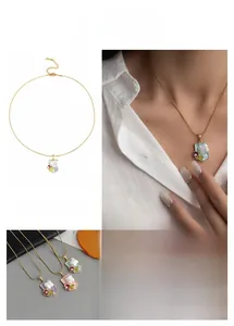 Detail of shield-shaped necklace with pearls and floral motifs in French luxury style