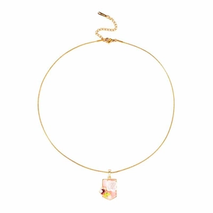 Macro detail of golden stainless steel necklace with a floral shield pearl pendant