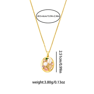 Detail of oval gold flower pendant with pink zircon and white pearls on thin chain