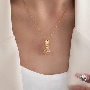 Chic gold shuttlecock and racket pendant necklace for women on minimalist clothing