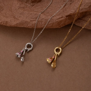 Minimalist badminton racket and shuttlecock pendant necklace in silver and gold steel finish