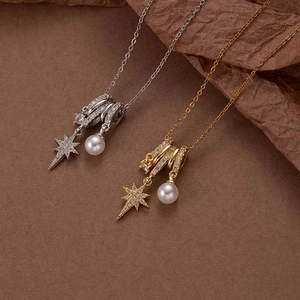 Star-shaped necklace set with white pearls and sparkling zircons in gold and silver